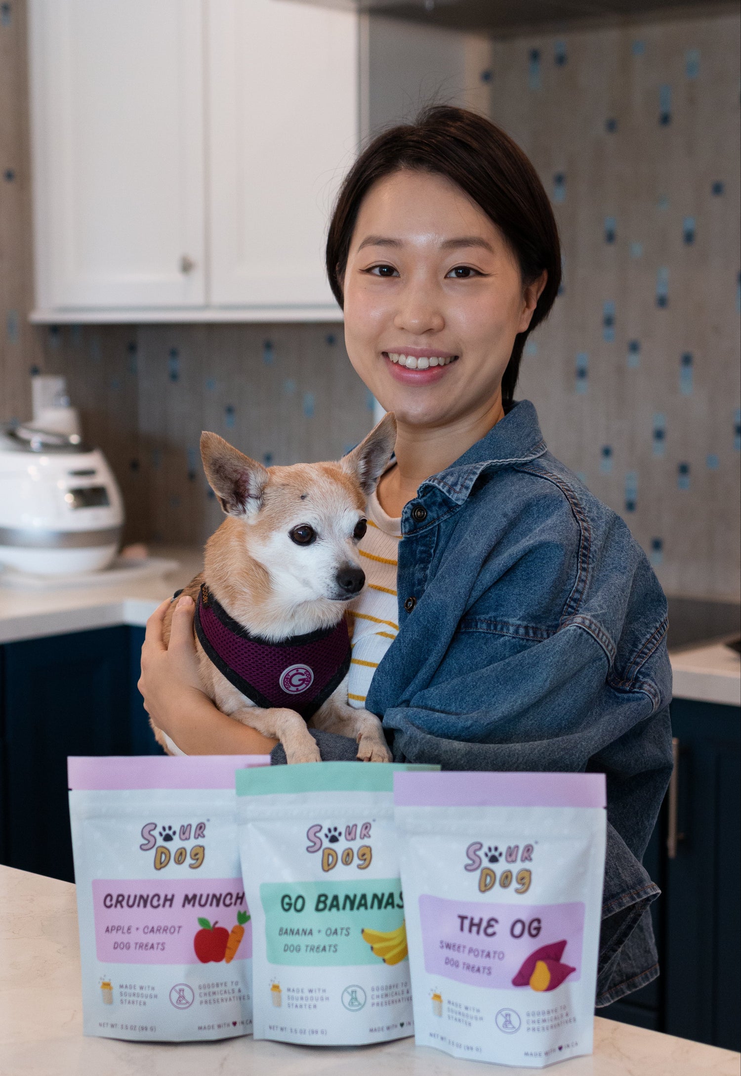 Monica, founder of SourDog, with her dog Ziggy and treats